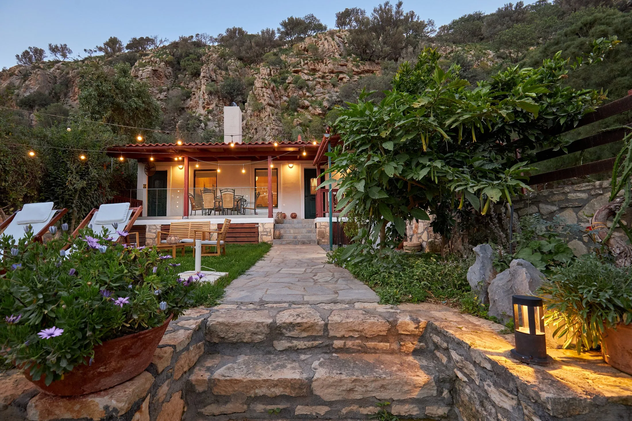 Yiamas Seaside Cottage garden and exterior lights at dusk Yiamas Seaside Cottage garden and exterior lights at dusk