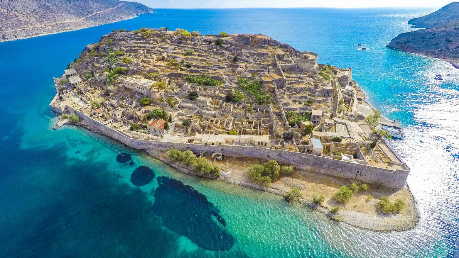 Excursion destination in Crete with turquoise water and historic island ruins Excursion destination in Crete with turquoise water and historic island ruins